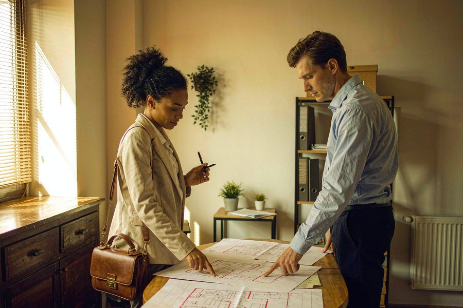 Reviewing floor plans on the buyer's side of the table